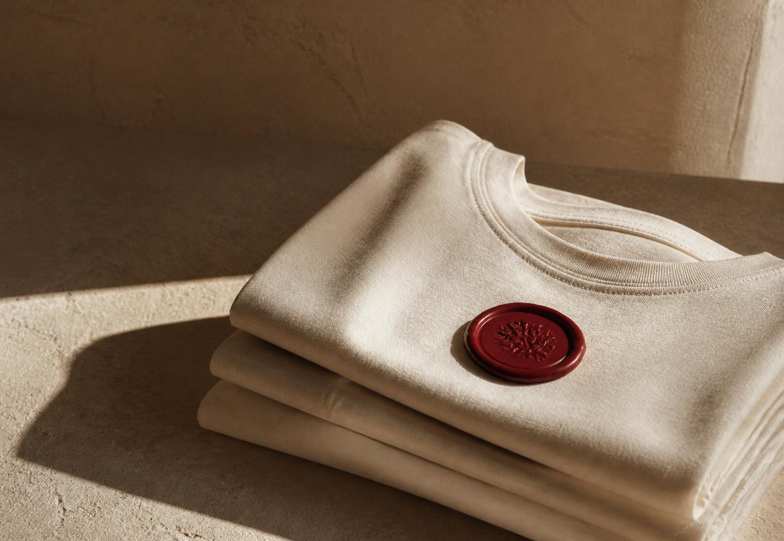 Folded bookcase garments in warm light with a red wax seal